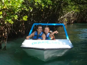 speed boat in cancun tours couple in the mangrove